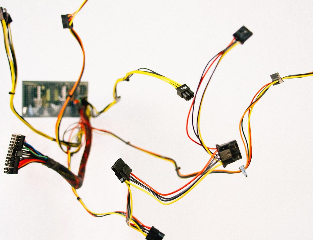 Colourful computer power cables and connectors on a white background